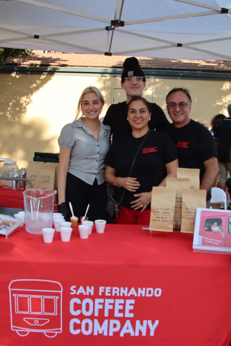 two women and two men behind a table for San Fernando Coffee at Taste of Arcadia